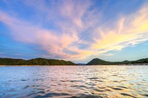 Beautiful sunrise time  with the sunlight shade in the sky and water in the dam photo