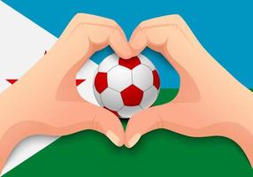 pelota de fútbol de djibouti y forma de corazón de mano vector