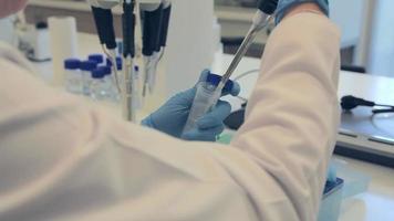 Lab work. Scientist working on tubes and liquid in lab. video