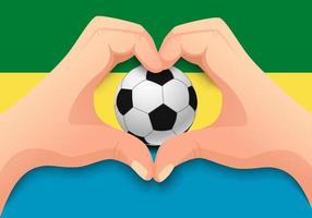 balón de fútbol de Gabón y forma de corazón de mano vector