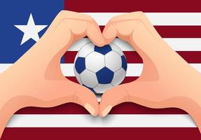 Balón de fútbol liberia y forma de corazón de mano vector