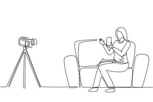 Single one line drawing female influencer filming video review smartphone on dslr camera at home. Blogger advertising tech product, streaming live. Continuous line draw design vector illustration