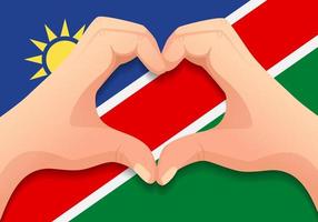 bandera de namibia y forma de corazón de mano vector