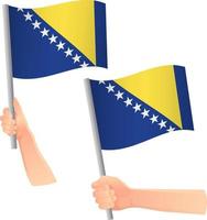 icono de la bandera de bosnia y herzegovina en la mano vector