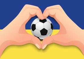Balón de fútbol de Ucrania y forma de corazón de mano vector