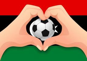 Balón de fútbol de libia y forma de corazón de mano vector