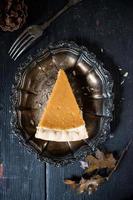 Pumpkin pie slice in fall holiday setting flat lay photo