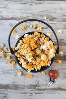 Halloween popcorn in fall colors in cauldron flat lay photo
