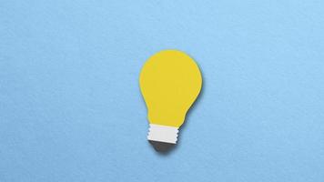 yellow paper light bulb emitting light concept idea. stop motion Design video