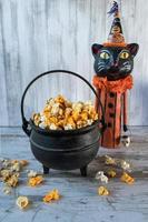 Halloween popcorn in fall colors in cauldron photo