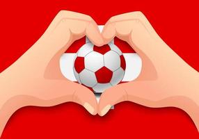 balón de fútbol suiza y forma de corazón de mano