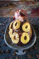 Cooked Thanksgiving ham with pineapple slices and spices photo