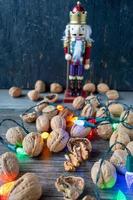 Christmas Nutcracker with whole walnuts and string lights photo