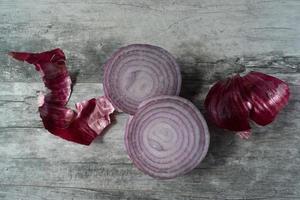 sliced red onions on rustic wood photo