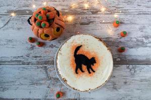 Halloween black cat pumpkin spice cake with decorations flat lay with copy space photo