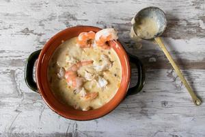 hot creamy seafood chowder in bowl top view photo