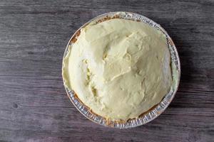 vanilla pudding pie with graham cracker crust in tin pie pan photo