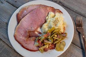 rustic Thanksgiving plate of baked ham with mash potatoes and green beans flat lay photo