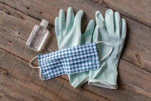 cleaning in a country rustic setting with gloves, masks, and sanitizer top view photo