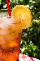 ice tea with lemon on summer picnic table outdoors photo