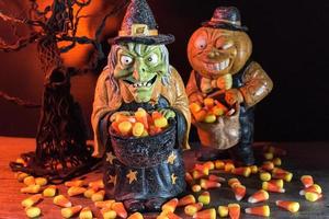Halloween characters in spooky background collecting candy corn photo