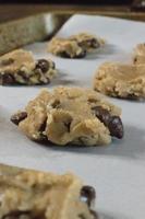 raw chocolate chip cookie dough on baking sheet photo