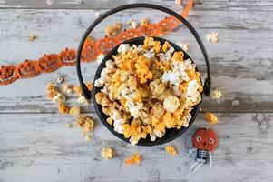 Halloween popcorn in fall colors in cauldron flat lay photo