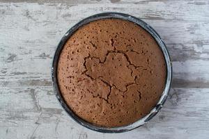 plain round chocolate cake baked top view photo