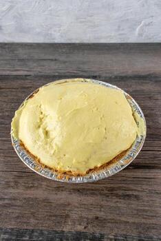 vanilla pudding pie with graham cracker crust in tin pie pan photo