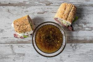 Roast beef sandwich with French Onion Dip beef broth flat lay photo