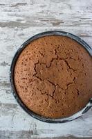 plain round chocolate cake baked top view photo