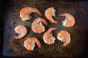 fresh shrimp with butter on baking pan flat lay