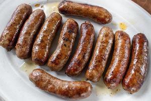 large plate of fried golden brown Italian sausages photo