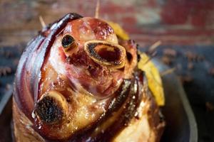 Cooked Thanksgiving ham with pineapple slices and spices photo