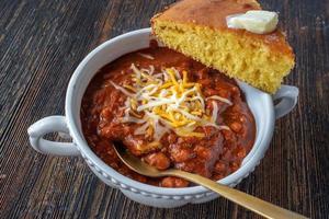 bowl of homemade chili with cornbread top view photo