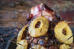 Cooked Thanksgiving ham with pineapple slices and spices photo