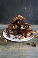 stack of homemade Walnut and chocolate brownies on plate photo