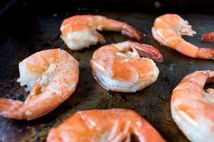 fresh shrimp with butter on baking pan photo
