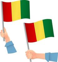 icono de la bandera de guinea en la mano vector