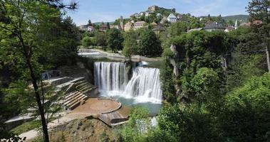 Pliva Waterfall in Jajce, Bosnia and Herzegovina. Holidays and travel. Water. Vibrant colors. Scenic place and viewpoint. Historical town. Tourist destination. video