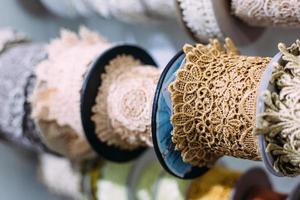 Skeins of lace hang on a shelf in a craft and craft store. photo