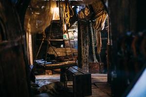 Wooden winch of a sailing ship and ropes on the deck of medieval pirate warship photo