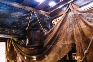 Wooden winch of a sailing ship and ropes on the deck of medieval pirate warship photo