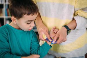 Mom gives her son his first watch. Learning to determine the time by the clock. photo