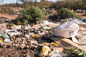 Brasilia, Brazil, June 20, 2022 Trash mostly cardboard and plastic bottles that homeless people pick up and dump out where the live in the Northwest sector of Brasilia photo