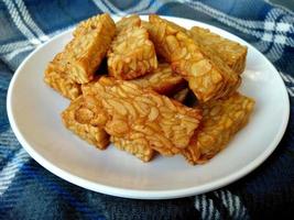 Tempe goreng or Fried Tempeh on a plate. Indonesian culinary food photo