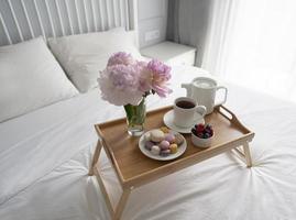 Tray with breakfast on bed. photo