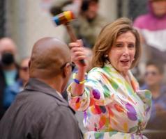 San Francisco, CA, USA - June 22, 2022, Pride Parade, Nancy Pelosi, Speaker of the House of Representatives, in the parade with her rainbow gavel photo