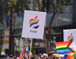 San Francisco, CA, USA - June 22, 2022, Pride Parade, Apple Corporation Contingent member carrying Apple Pride logo photo