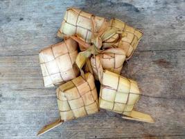 Ketupat or Rice Dumpling On Wooden Background. Indonesian culinary food photo